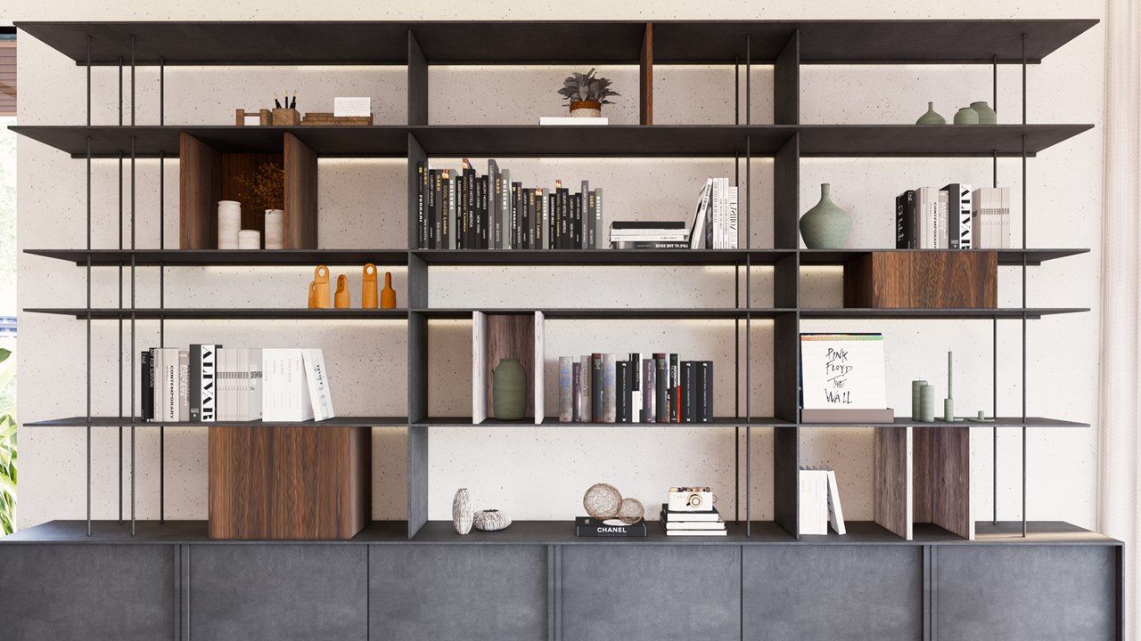 Steel and walnut bookshelf wall with integrated lighting, styled with books and ceramics