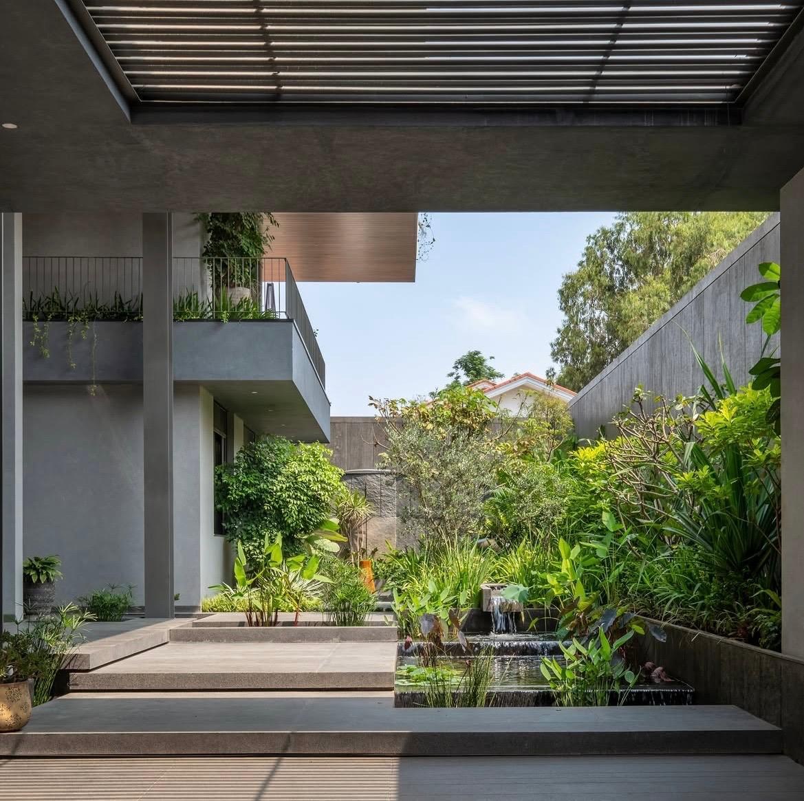 View from under the louvred pergola at The Stepped Haven to the stepped water feature and garden